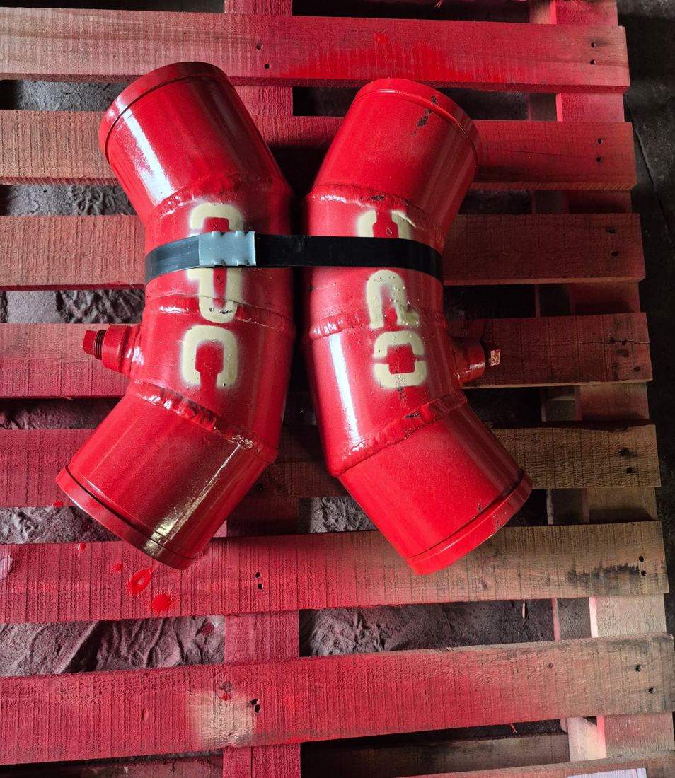 Two Hrd67 elbows with bungs in red enamel, strapped together on a red pallet