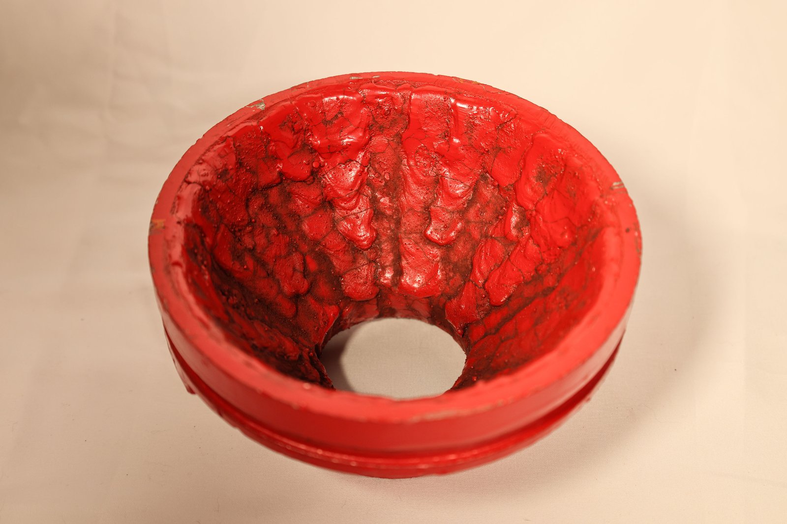Looking down into the bore of an overlaid 6 by 3 concentric reducer: the weld deposit laid in beads over the full interior