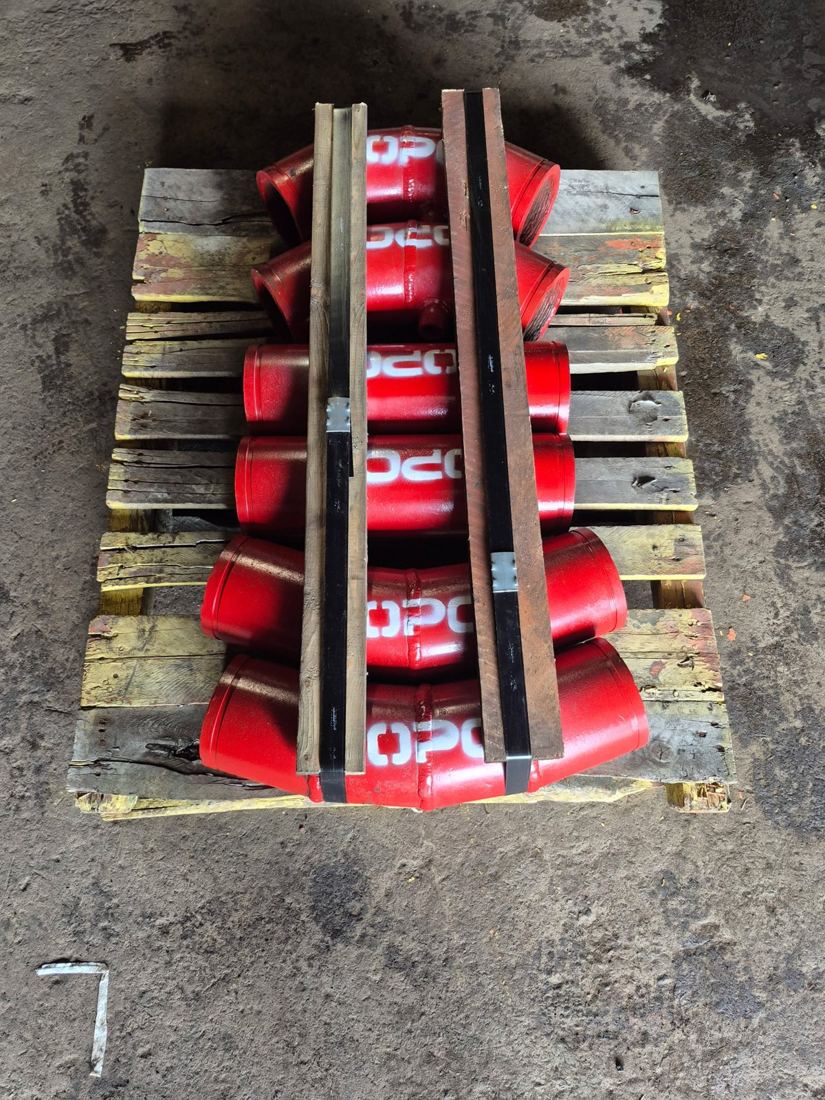 A full pallet of Hrd67 elbows and spools in red enamel, stencilled OPC, separated by wood battens